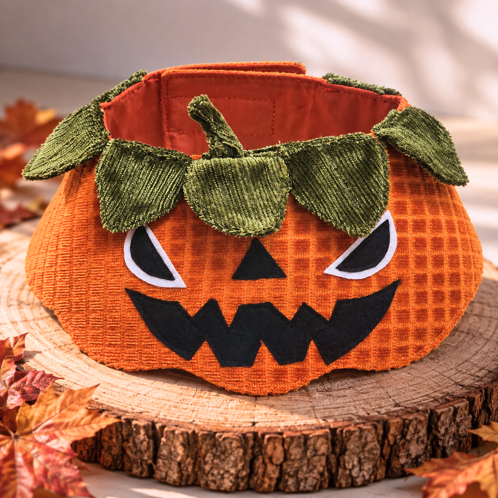 Orange jack-o’-lantern pet collar with green leafy trim